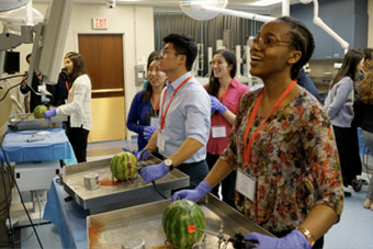 Students practice arthroscopic surgery on a watermelon