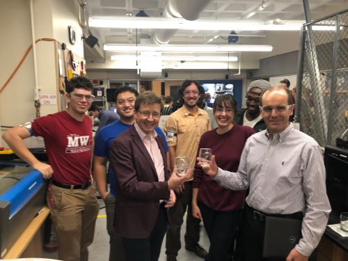 Students showing engraved glasses they made with Professors Pierre Lermusiaux and Gareth McKinley