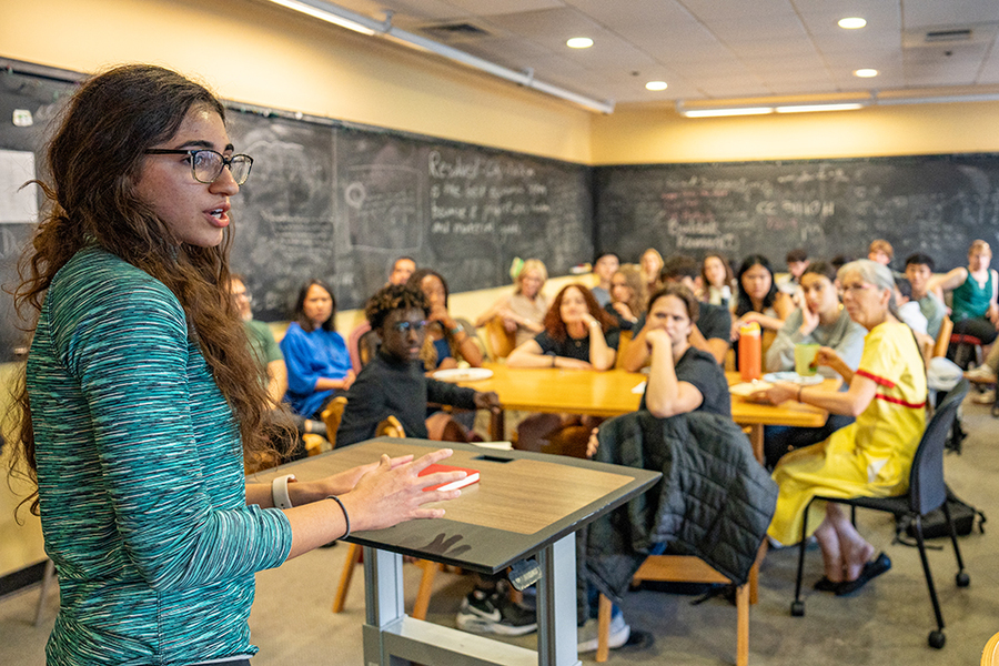 Student speaking in front of a classroom