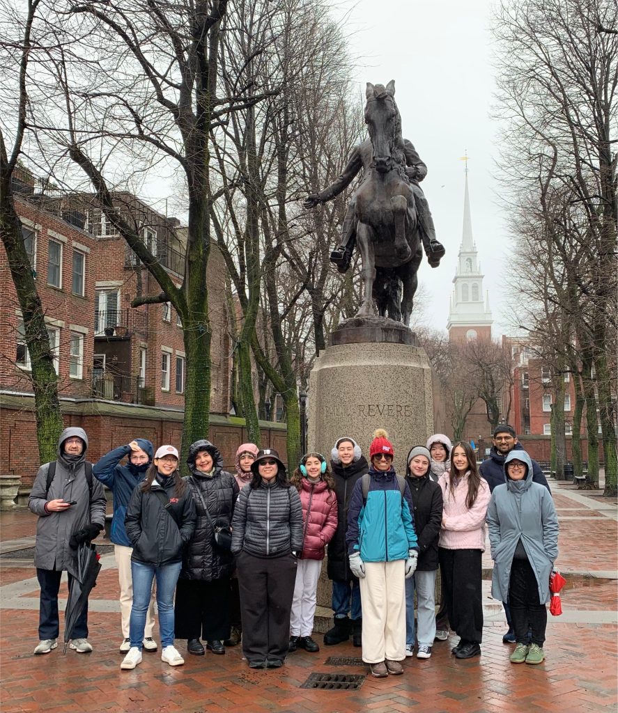 Photo of a group of MIT students in front of a statue of Paul Revere in the North End.